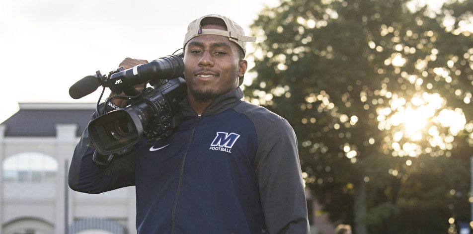 Student worker holding camera