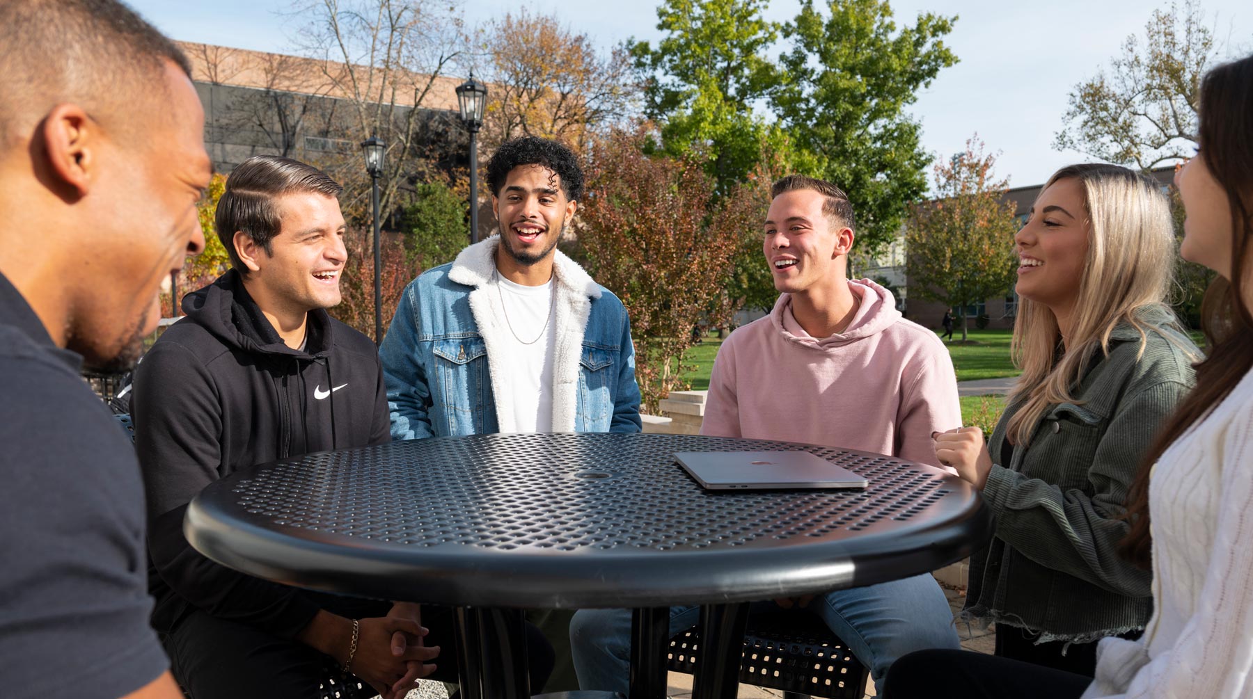 Group of diverse students sitting around table