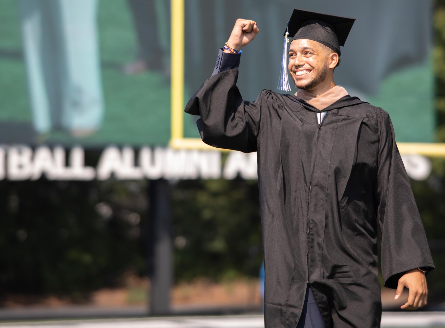Student graduating with fist in air