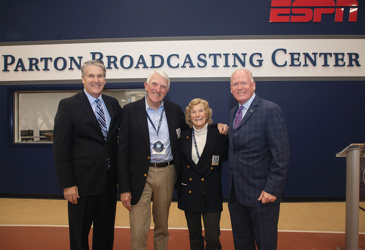 Patrick F. Leahy, Charles and Trudy Parton, Jeff Stapleton standing in front of the ESPN sponsored Parton Broadcasting Center.