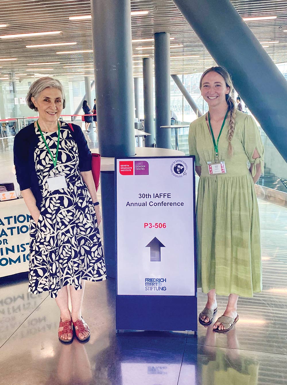 Nahid Aslanbeigui, Ph.D. in black and white vine patterned dress, and Jordan Petchel ’21, ’22M in green dress