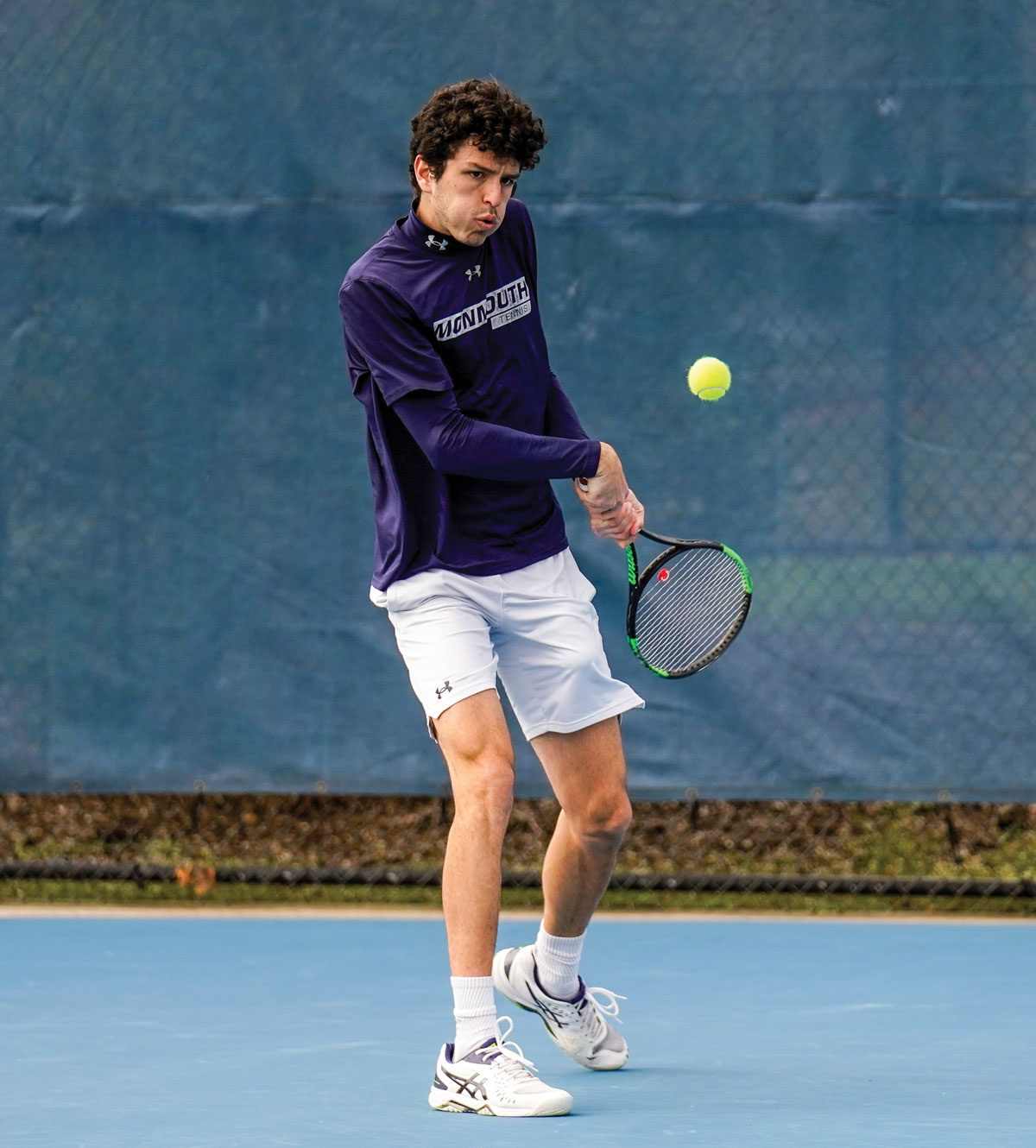 an action shot of tennis player about to hit ball with racket