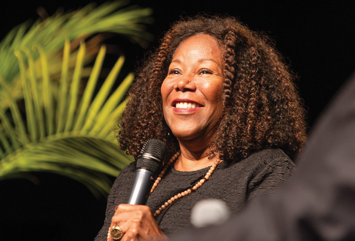 Ruby Bridges smiling while holding a microphone 