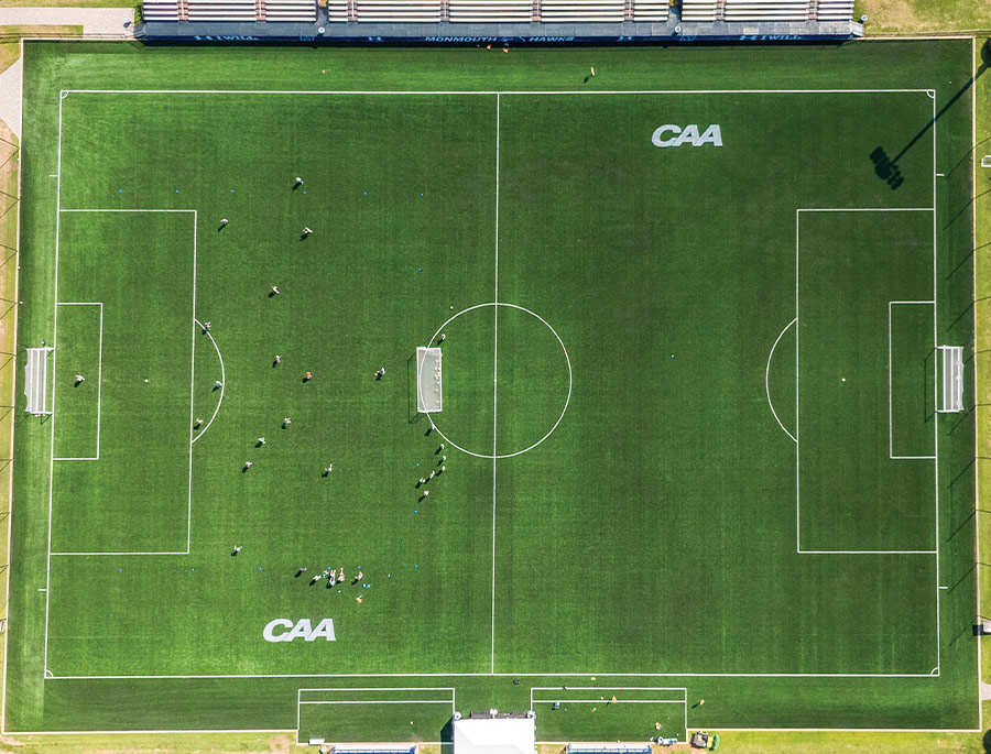 drone view direcly above a field labeled CAA for the Coastal Athletic Association